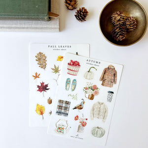 Autumn sticker sheets with watercolor fall leaves, an apple basket, white pumpkins, a plaid coat, and a cozy sweater