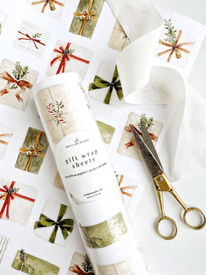 Christmas gifts wrapping paper sheets rolled in a clear package on a matching sheet of watercolor presents, with scissors