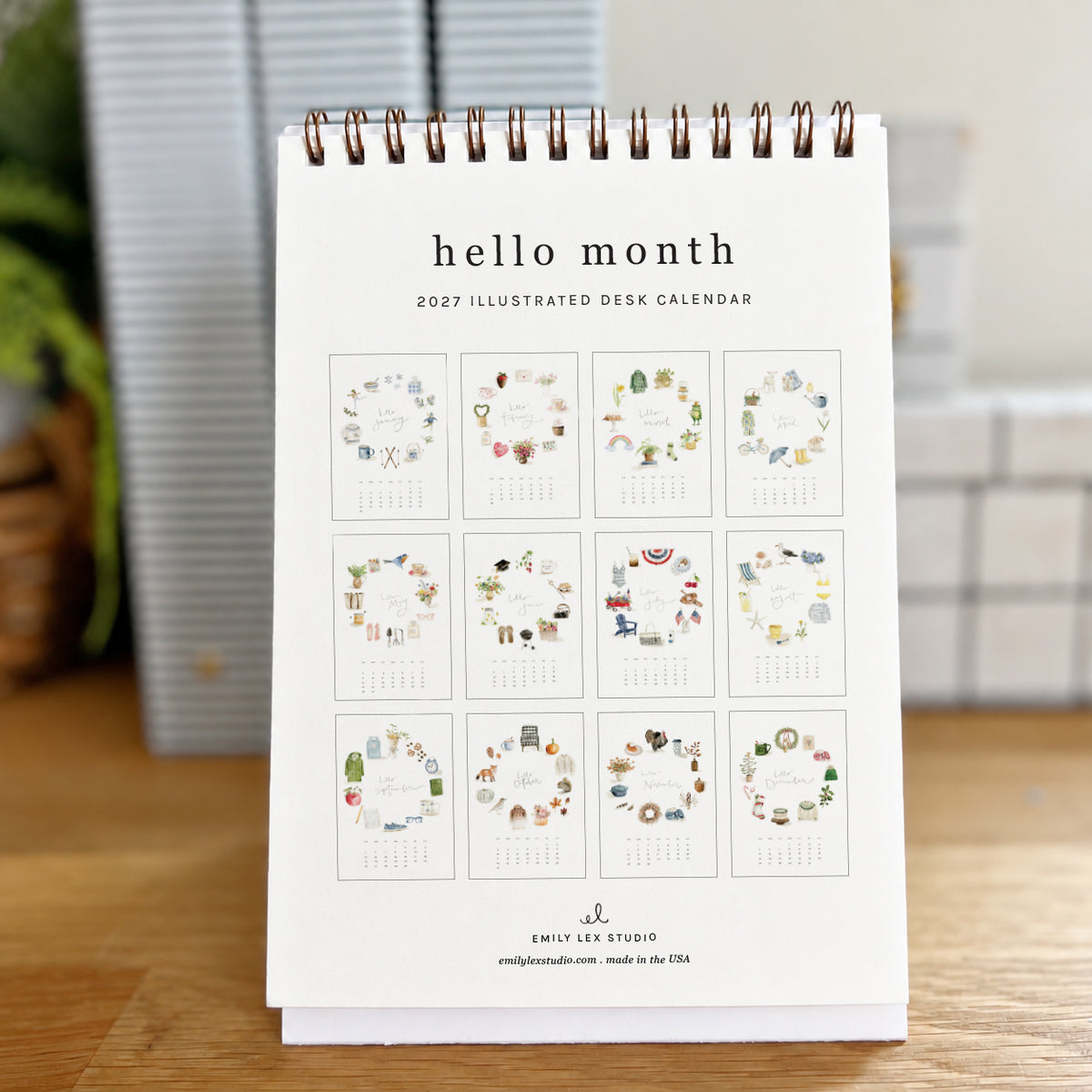2027 hello month desk calendar back showing a grid of all 12 monthly pages with watercolor icon wreaths
