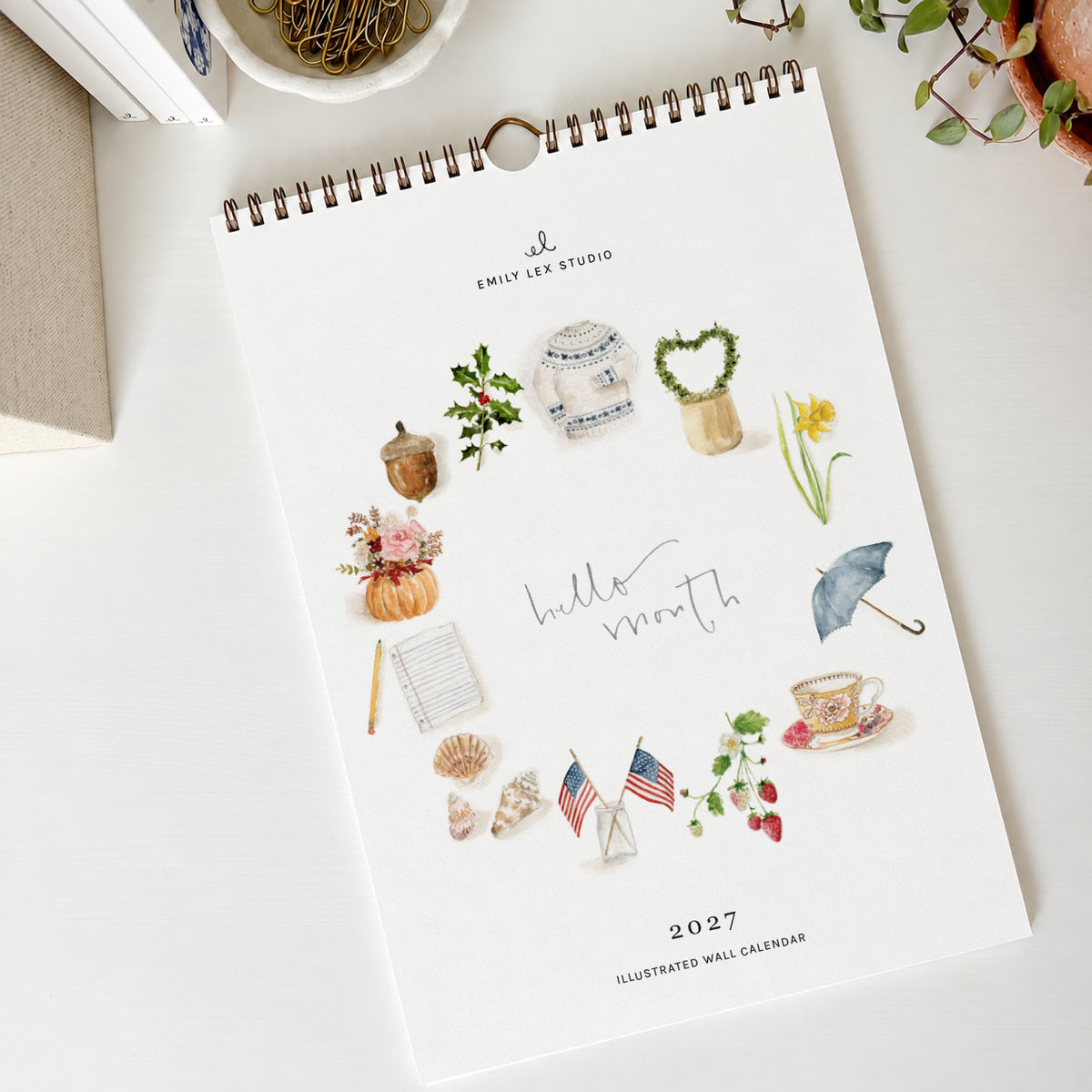 2027 hello month wall calendar cover with a ring of watercolor seasonal icons around the words hello month