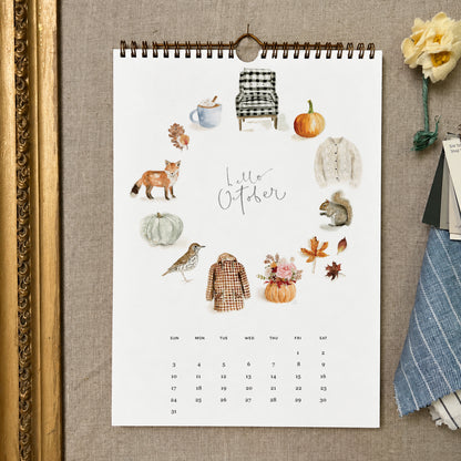 2027 hello month wall calendar October page with watercolor autumn icons like a fox, squirrel, pumpkins, and leaves